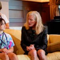 close up students and Shelley Irwin, WGVU host, on a yellow couch